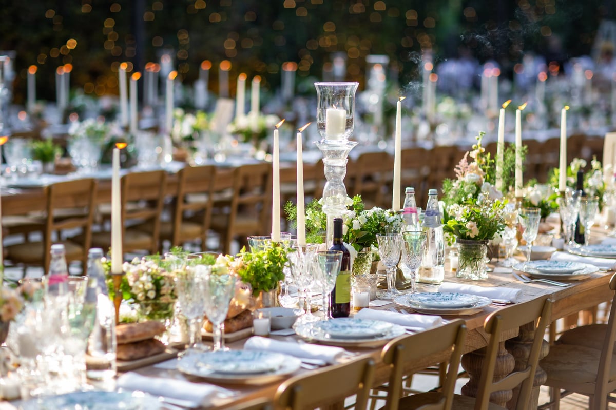 Elegant outdoor candlelit banquet with floral decor